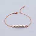 Macro detail of rose gold geometric hexagon bracelet featuring shimmering cubic zirconia - Bracelet / Rose Gold