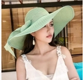 Women's wide brim straw sun hat in light green with a decorative bow detail - One Size / Solid Mint Green