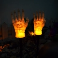 Solar Halloween skeleton arm stakes with warm yellow glowing skulls for garden path - Ghost Hand Stake Single (Flame)