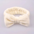 Creamy white coral fleece headband with large bow for skincare and facial cleansing - Off White