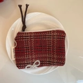 Detail of red and black tartan wool coin purse with white bow and woven logo label - Dark Red Plaid Large Bow