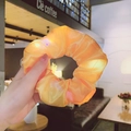 Luminous orange organza scrunchie with LED lights shown in a warm coffee shop setting - LED Light Orange