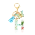 Letter H resin keychain with green stones, gold foil, dried flower and blue tassel - Letter H
