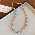 Detailed shot of alternating white and silver pearl necklace with metallic clasp on tray - 39# Grey 6mm Pearl Necklace