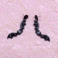 Halloween acrylic bat earrings with skull pattern on a pink textured background - Skull Bat
