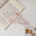 Pink jelly bow hair claw clip placed on a book for a gentle aesthetic look - Frosted Bow Pink / 13cm