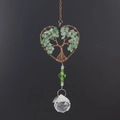 Close-up of heart-shaped tree of life suncatcher with green stones and crystal ball - Green Aventurine Heart Style