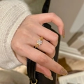 Detailed view of floral ring with sparkling diamonds on hand against stylish background - Adjustable / Gold Snowflake Ring
