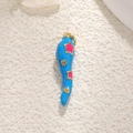 Detailed view of a blue enamel chili pepper pendant with gold trim and pink stars - Blue with Stars