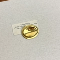 Detailed close-up of a gold irregular pebble brooch with a polished mirror finish - 9 Oval Gold (Z-3659)