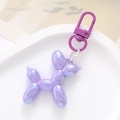 Detail of purple iridescent acrylic balloon dog keychain on white tray background - Purple