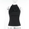 Close-up detail of glossy satin fabric and halter neck design on black backless crop top - XS / Black