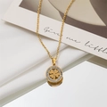 Close-up of golden clover pendant necklace with sparkling zircon halo on white silk - Four-Leaf Clover