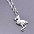 Macro view of a silver flamingo pendant necklace with detailed feather textures on O-chain - Necklace Set / Steel