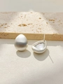 Detail of matte brushed silver teardrop earrings showing hollow back and needle on stone - Silver
