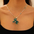 Handmade woven coconut tree pendant necklace with colorful beads on a female model - Coconut Tree (KX294)