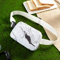 Waterproof marble pattern waist bag with adjustable white strap on a green moss background - Marble White