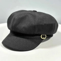 Classic black newsboy hat featuring textured twill fabric and a gold metal side button - One Size / Black
