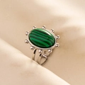 Macro detail of oval malachite ring with sunburst silver setting and hollow band - Silver & Green
