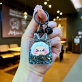 Detailed macro view of creative liquid quicksand keychain with cartoon sheep and black bell - Black Night Light Bubble Beads