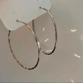 Macro view of silver twisted hoop earrings with textured hammered finish and metallic shine - 4# Silver Earring Post - Silver - Hammered - Large