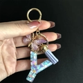 Close-up of resin letter Y keychain with colorful heart sequins and butterfly charm - Letter Y / Butterfly Tassel 8-Shape Buckle