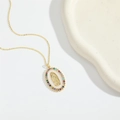 Detail of gold oval pendant featuring Virgin Mary icon and colorful gemstone accents - Rainbow Zirconia Virgin Mary