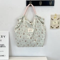 Detail of cartoon animal print on pleated green checkered tote with braided rope handle - Salt Style Bunny