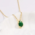 Elegant gold necklace with a pear-shaped emerald pendant displayed on a textured plate - Style 1 Gold (Pear Shape)