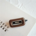 Simple brown rectangular hair clip with a glossy finish on a minimalist notebook - Square Coffee