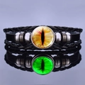 Macro shot of steampunk dragon eye leather bracelet with a glowing glass cabochon focal point - Orange-Yellow Beast Eye Style