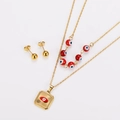 Detail of double-layer gold necklace with red evil eye pendant and matching stud earrings - Gold Red