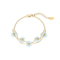 Delicate gold flower bracelet with light blue beads on a clean white background - Bracelet / Gold-Light Blue