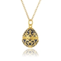 Detailed macro view of a gold and blue enamel egg pendant with intricate cutout patterns - Blue