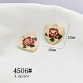 Macro shot of gold heart-shaped pendants with white enamel and red rose details - 4506# Heart Rose