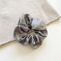 French vintage metallic silver scrunchie with pleated texture on a soft knit surface - Medium / Light Gray