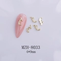 Macro shot of 4x9mm gold bow alloy nail art charms with baroque scroll patterns - Gold Curly Pattern Style (8033)