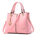 Pink faux leather handbag for women with gold hardware and heart pendant on white background - 29*12*24 / Pink