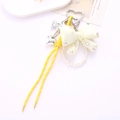 Detail of yellow nylon cord phone strap with rhinestone bow and pearl accents - Braided Rope + Rhinestone Bow Pendant Yellow (K4545)