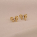 Close-up of golden double-layer bow earrings with rectangular cubic zirconia accents - Gold Bow White Zirconia / White