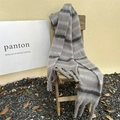 Detailed view of thick grey striped knit scarf with long decorative fringe on a chair - Striped Premium Grey