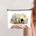 Detail of canvas pencil case with watercolor cat prints held in hand for scale - Three Cats on Sofa Style
