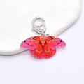 Detail of pink gradient acrylic butterfly keychain with silver heart clasp and glitter finish - Red & Pink Butterfly (Heart Clasp)