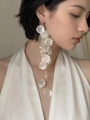 Close-up of elegant long tassel earrings with white shell pieces and pearls on a model - Single Shell Tassel Ear Clip / White