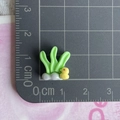 Miniature seagrass and duck resin charms on a grid mat showing 2cm scale detail - Duck and Seagrass