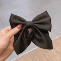 Detail of the high-quality black satin bow hair clip with smooth and glossy texture - Black