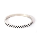 Detailed macro view of the silver stainless steel bangle with black and white checkerboard enamel - Checkerboard Style (DQ-2294) / 18K Gold / Silver