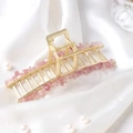 Detail of golden alloy hair claw clip featuring pink crystal stone chips on silk - Strawberry Quartz Large/11cm