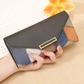 Handheld patchwork leather long wallet with golden metallic clasp and pebbled texture - Patchwork Black