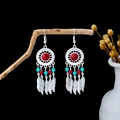Detailed Bohemian silver tassel earrings with red and blue beads on a rustic wood branch - Silver Red Blue Dreamcatcher Drop(E5986-3)